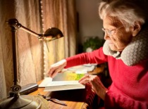 Prof. E. Grinienė reads at her desk, 2023. (Prof. E. Grinienė family archive)