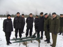 Staff members of the KTU Institute of Defense Technologies and representatives of the Lithuanian Armed Forces next to experimental missiles, 2009. From left: Dr. L. Pata&scaron;ienė, Prof. A. Fedaravičius, and A. Survila. (Photo by J. Klėmanas, KTU Photo Archive)