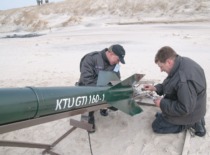 Prof. A. Fedaravičius and A. Survila, a researcher at the KTU Institute of Defense Technologies, inspect an experimental rocket before launch. Juodkrantė, 2011. (Photo by J. Klėmanas, KTU Photo Archive)